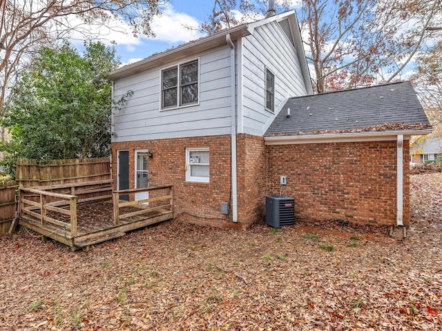 back of house with central AC unit and a wooden deck