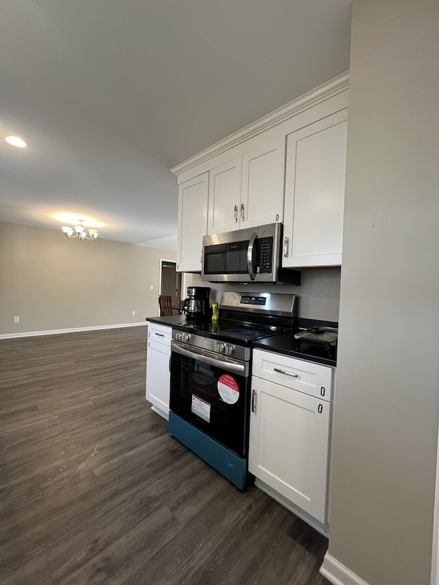 kitchen featuring white cabinets, appliances with stainless steel finishes, and dark hardwood / wood-style flooring