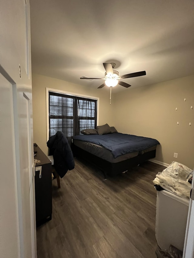 bedroom with ceiling fan and dark wood-type flooring