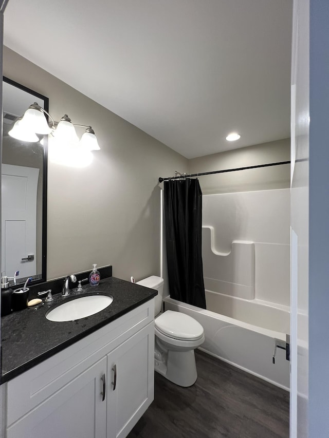 full bathroom with vanity, hardwood / wood-style flooring, toilet, and shower / bath combo with shower curtain