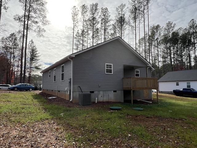 rear view of property with a yard and central air condition unit