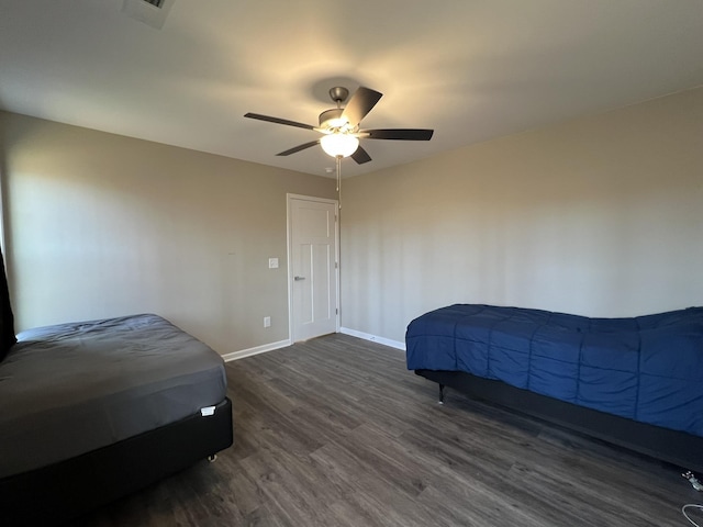 bedroom featuring dark hardwood / wood-style flooring and ceiling fan