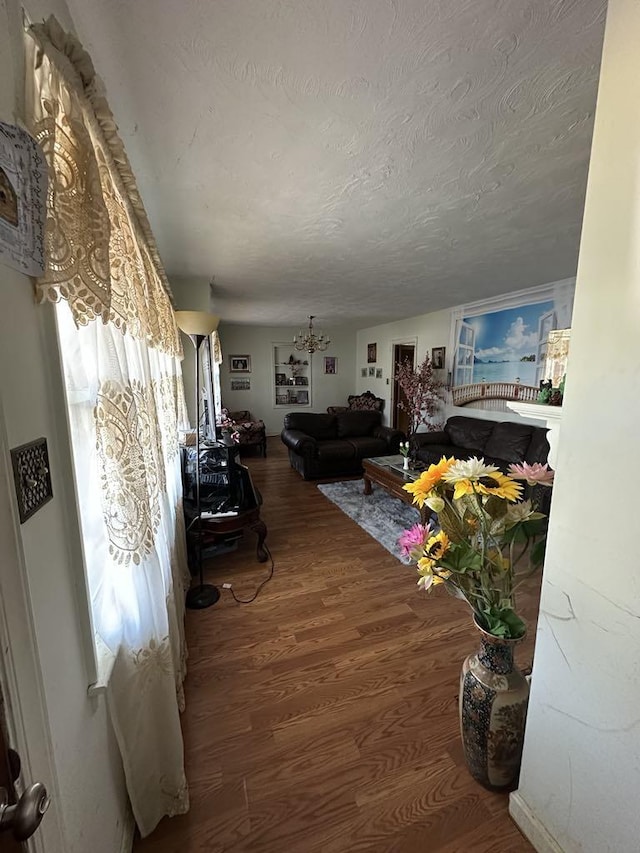 living room with hardwood / wood-style floors and a textured ceiling