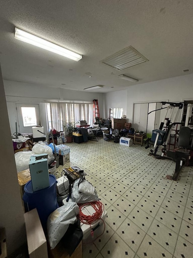 misc room with a healthy amount of sunlight and a textured ceiling