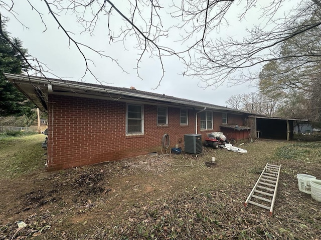 back of house with a hot tub and cooling unit