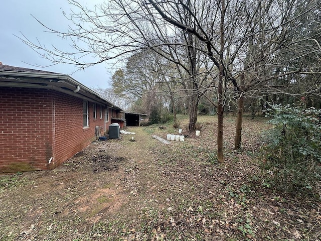 view of yard featuring central air condition unit