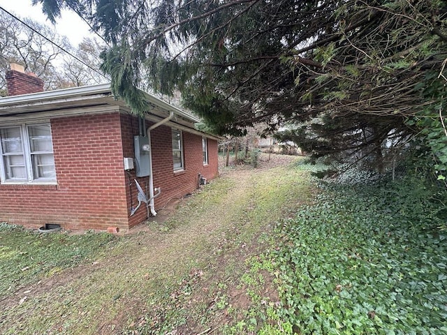 view of property exterior featuring a lawn