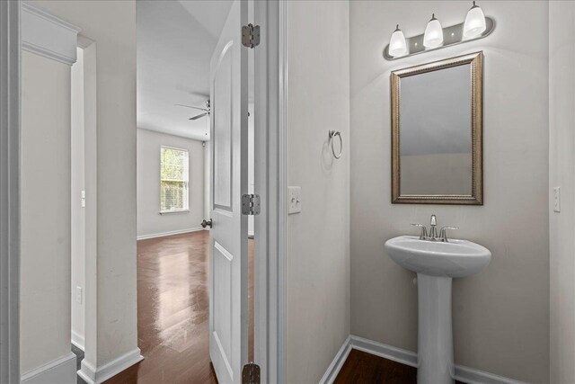 bathroom with hardwood / wood-style floors, ceiling fan, and sink