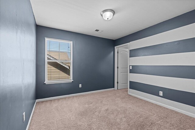 empty room with light colored carpet