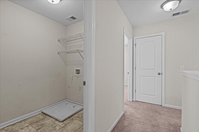 laundry room featuring light colored carpet and washer hookup