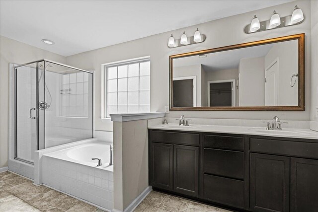 bathroom with separate shower and tub and vanity