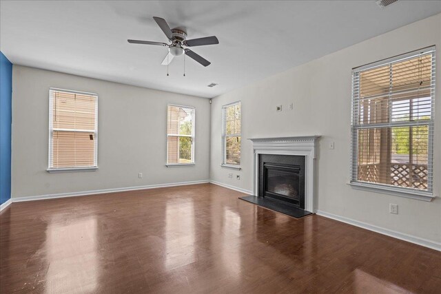 unfurnished living room with ceiling fan and dark hardwood / wood-style floors