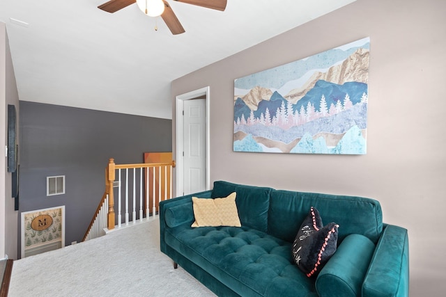 carpeted living room featuring ceiling fan