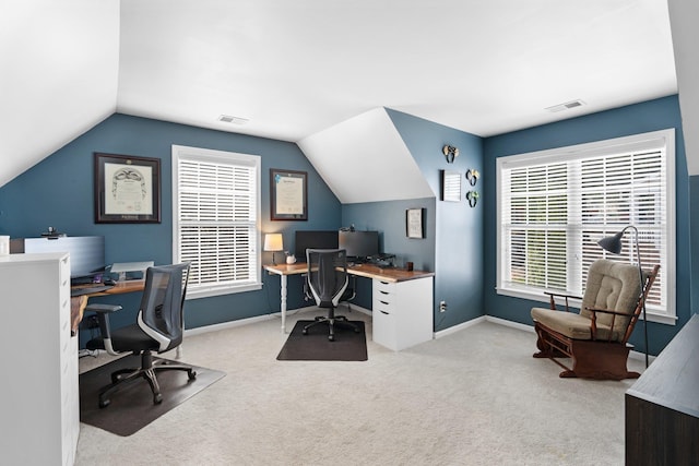 carpeted home office with vaulted ceiling and plenty of natural light