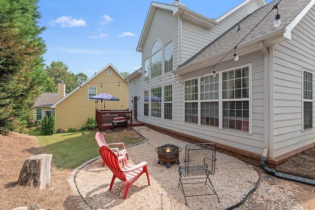 exterior space featuring a fire pit and a lawn