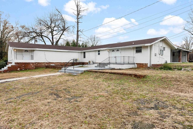 back of property featuring a lawn