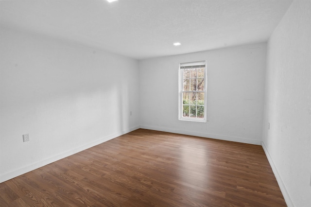 unfurnished room featuring dark wood-type flooring