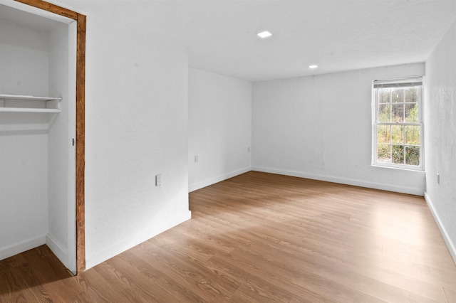 unfurnished bedroom with a closet and light hardwood / wood-style flooring