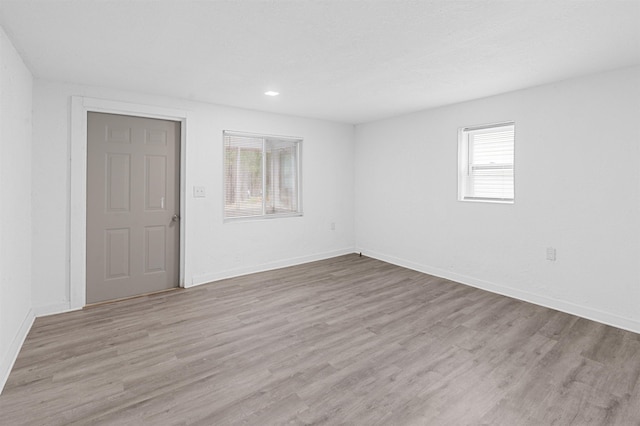 spare room with light hardwood / wood-style flooring