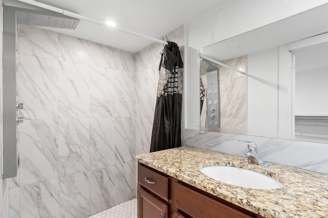 bathroom with curtained shower, vanity, and tile walls