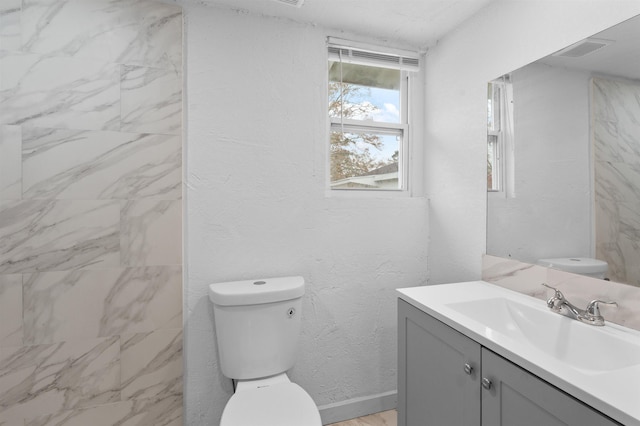 bathroom featuring vanity and toilet