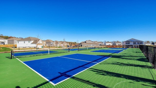 view of tennis court featuring basketball hoop