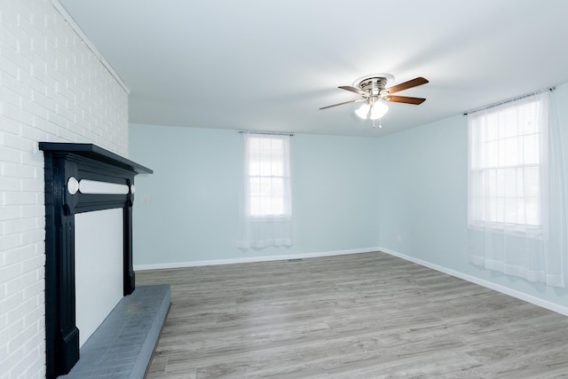 spare room with ceiling fan and light wood-type flooring