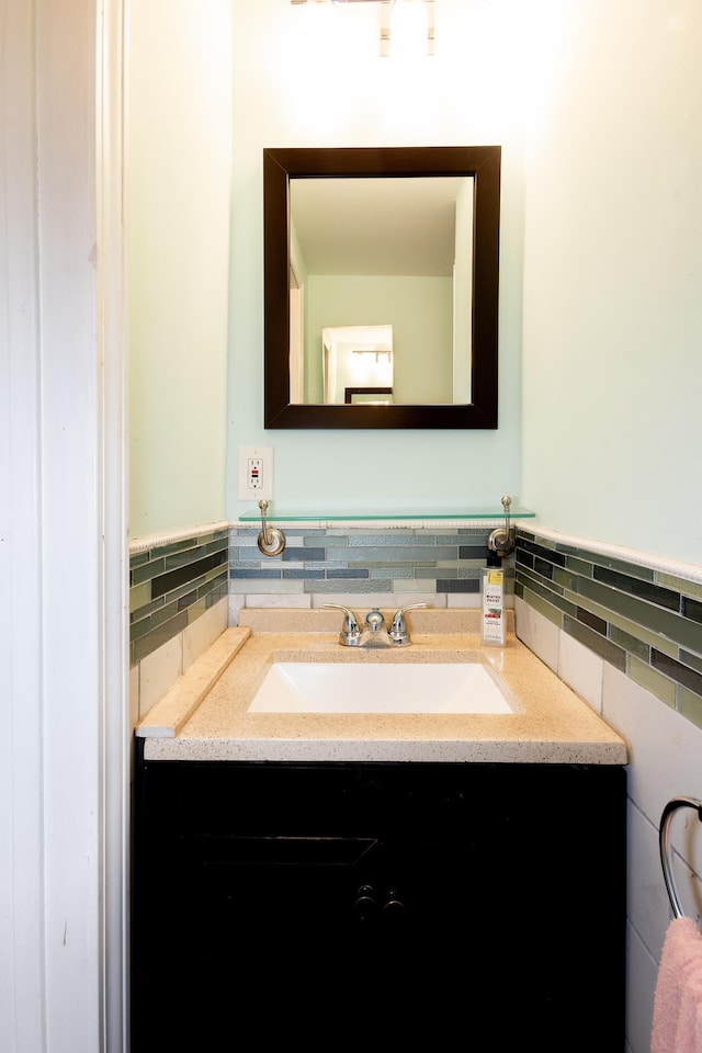 bathroom featuring vanity and tile walls