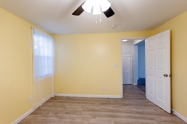 unfurnished room with ceiling fan and light wood-type flooring