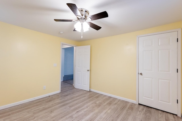 unfurnished bedroom with ceiling fan and light wood-type flooring