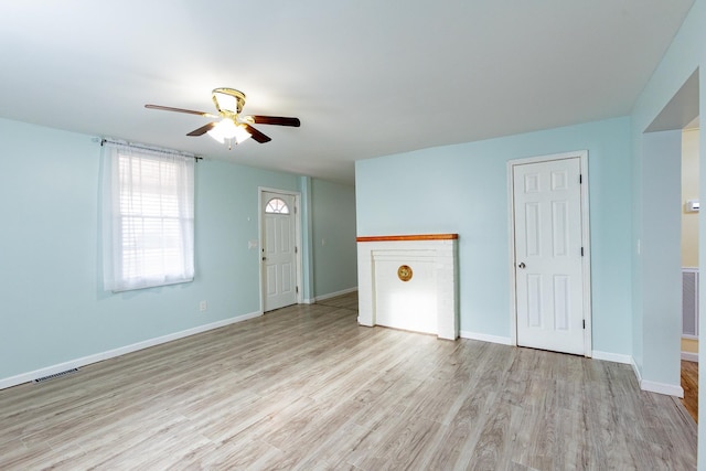 unfurnished living room featuring ceiling fan and light hardwood / wood-style floors