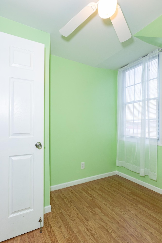 empty room featuring ceiling fan and light hardwood / wood-style flooring