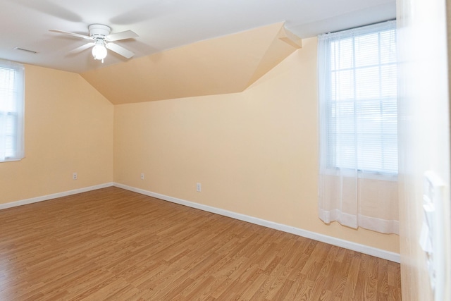 additional living space featuring hardwood / wood-style flooring, ceiling fan, and vaulted ceiling