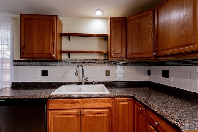 kitchen featuring tasteful backsplash, dark stone counters, black dishwasher, and sink