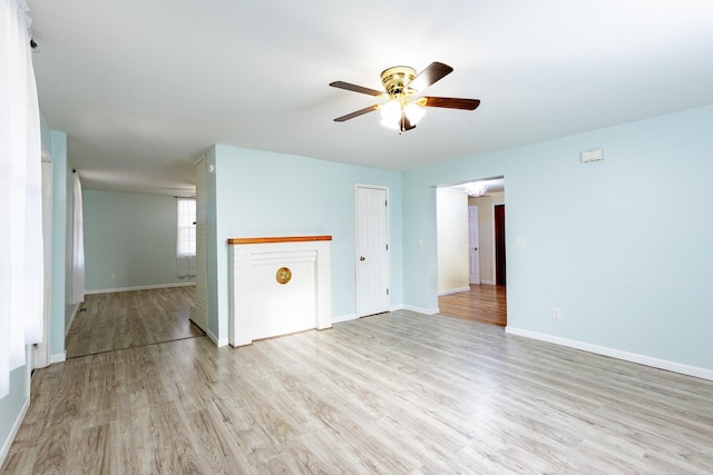 empty room with ceiling fan and light wood-type flooring