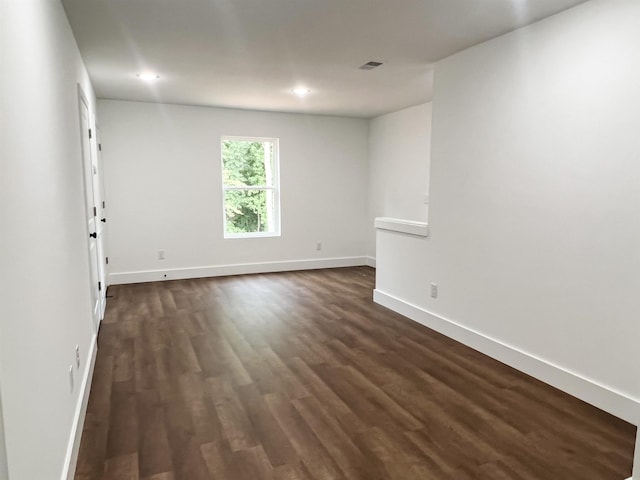 empty room with dark hardwood / wood-style floors