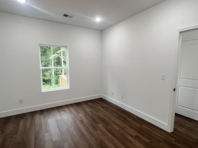 empty room with dark hardwood / wood-style floors