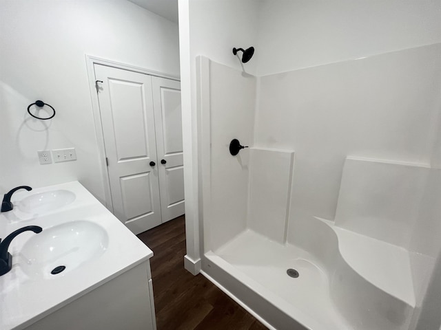 bathroom featuring vanity, wood-type flooring, and walk in shower