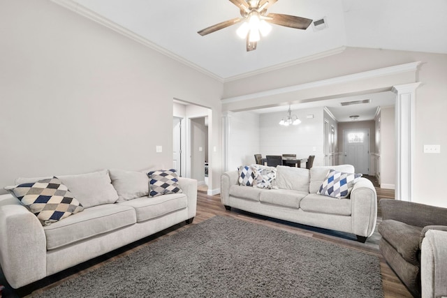 living room with ornate columns, ornamental molding, ceiling fan with notable chandelier, vaulted ceiling, and dark hardwood / wood-style floors