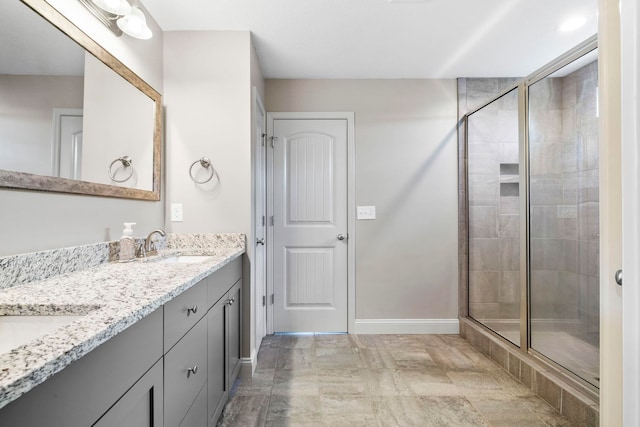 bathroom featuring vanity and a shower with shower door