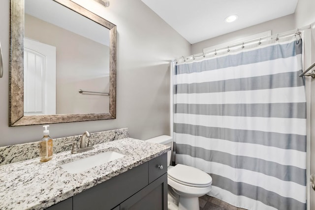 bathroom featuring a shower with curtain, vanity, and toilet