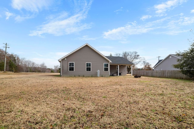 rear view of house with a lawn