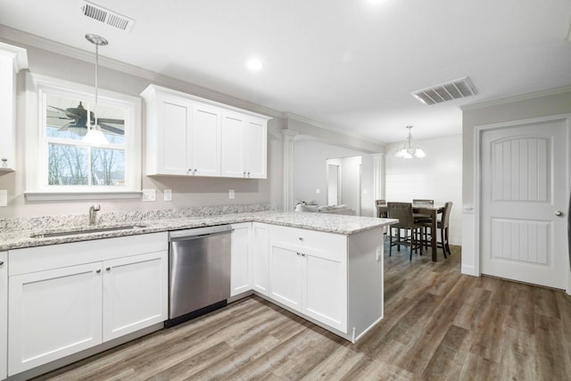 kitchen with dishwasher, pendant lighting, hardwood / wood-style flooring, and white cabinetry