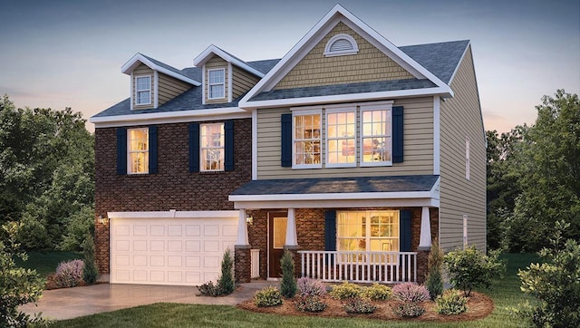 craftsman-style home featuring a lawn, a garage, and covered porch