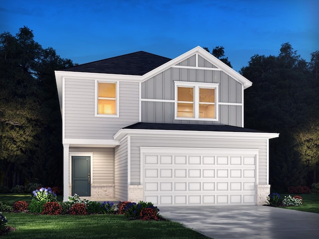 view of front of property featuring a garage and a front lawn