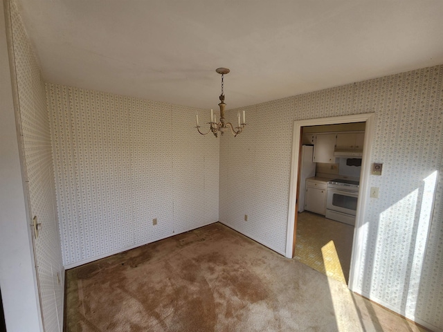 unfurnished dining area with carpet and a chandelier