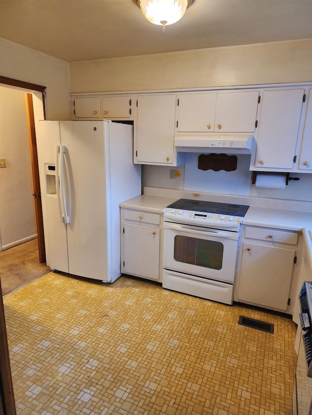 kitchen featuring white cabinets and white appliances