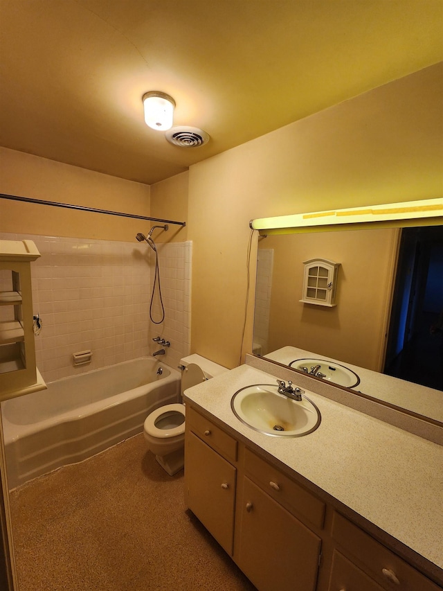 full bathroom featuring tiled shower / bath combo, toilet, and vanity