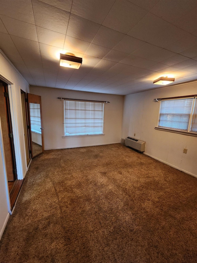 carpeted spare room featuring plenty of natural light