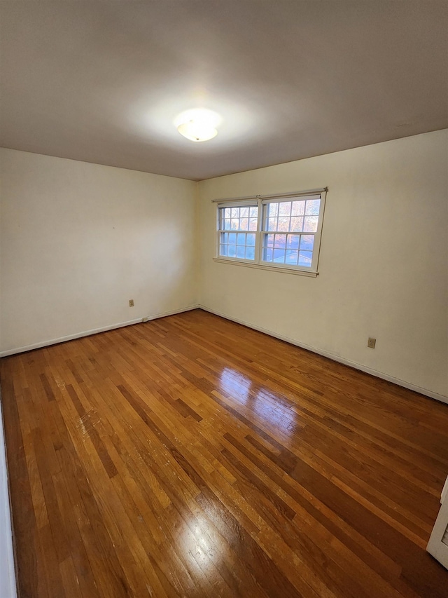 unfurnished room with wood-type flooring